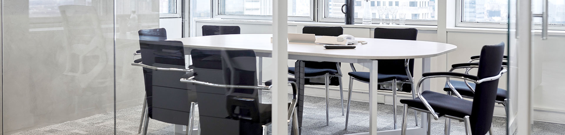 Clean and minimal conference room in a commerical office space with a city view